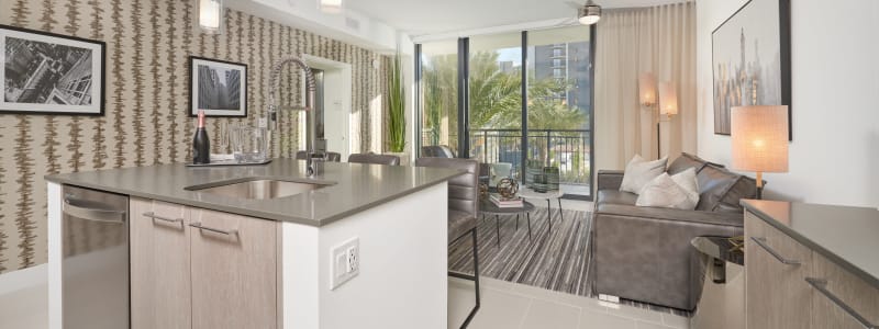 Kitchen island and living room at ParkLine Miami in Miami, Florida