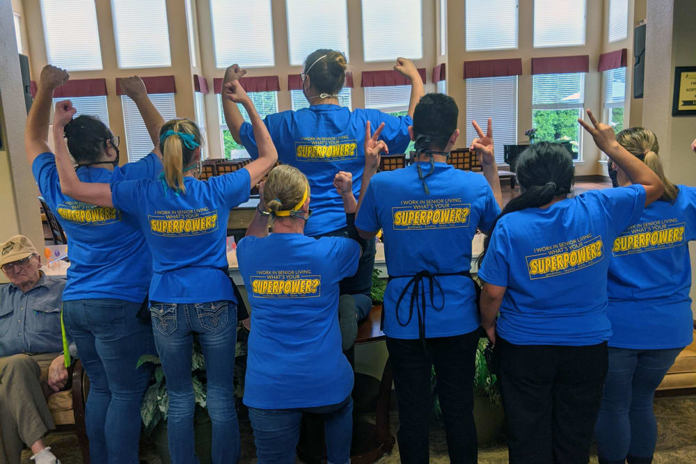 Staff members showing off their matching shirts at Heron Pointe Senior Living in Monmouth, Oregon