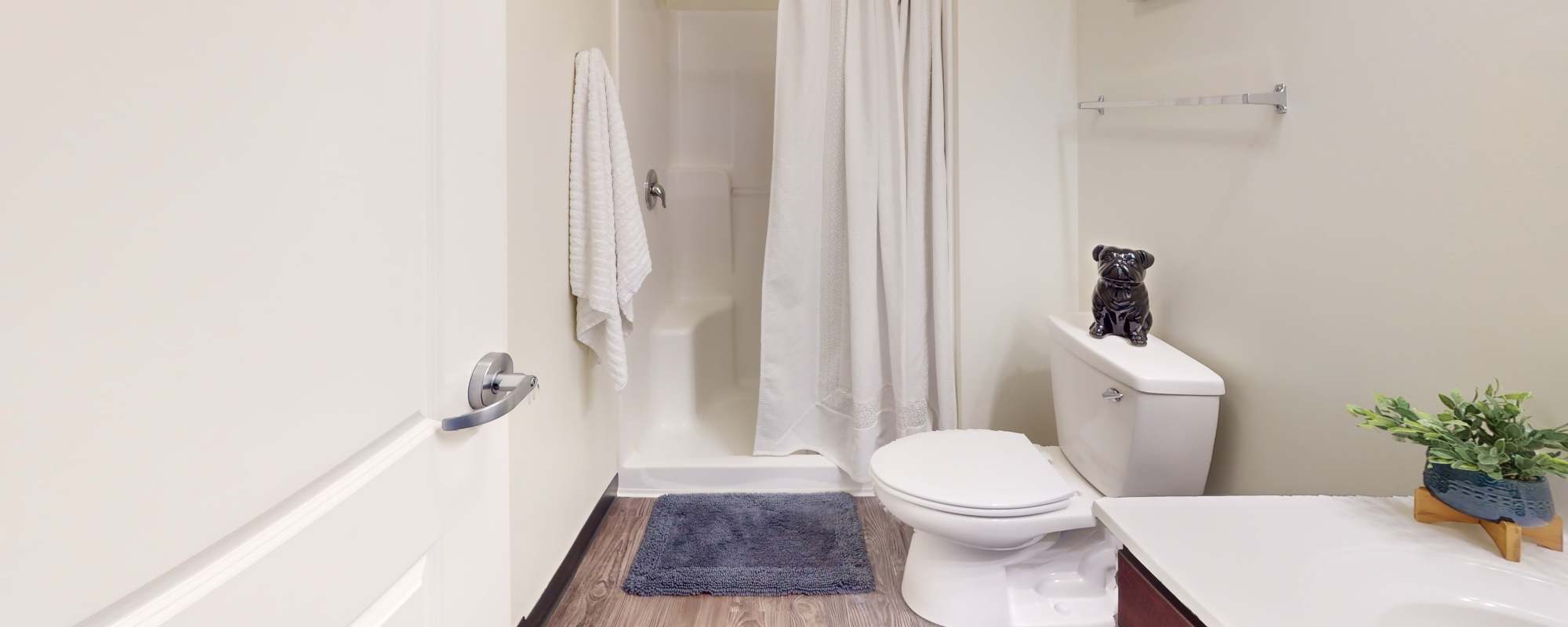 Apartment bathroom with bathtub and commode at Hudson Lofts in Erie, Pennsylvania