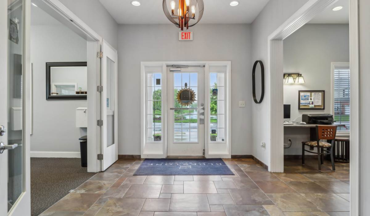 Living room with wood-style flooring at Bluestone in Greenfield,Indiana