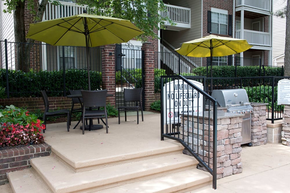 Poolside grilling station and shaded picnic area at Castlegate Collier Hills in Atlanta, Georgia