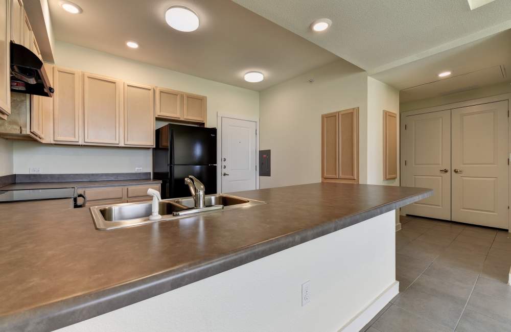 Kitchen with wooden cabinets at Homestead Oaks Apartments in Austin,Texas