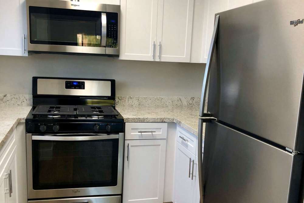 Compact kitchen with stainless steel appliances at The Indie Glendale Collection in Glendale, California