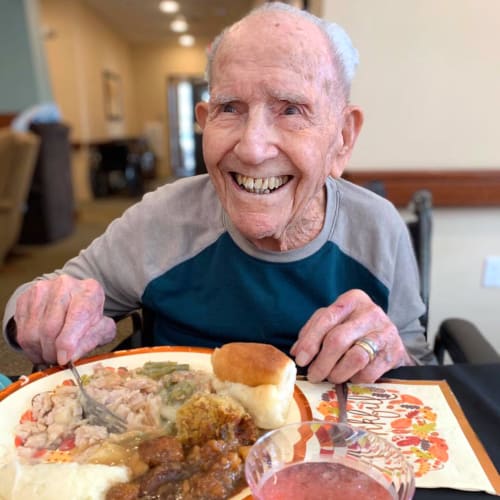 Resident with a plate of desert at Oxford Glen Memory Care at Owasso in Owasso, Oklahoma