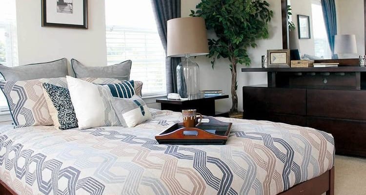 Enjoy apartments & townhomes with a cozy bedroom at The Encore at Laurel Ridge