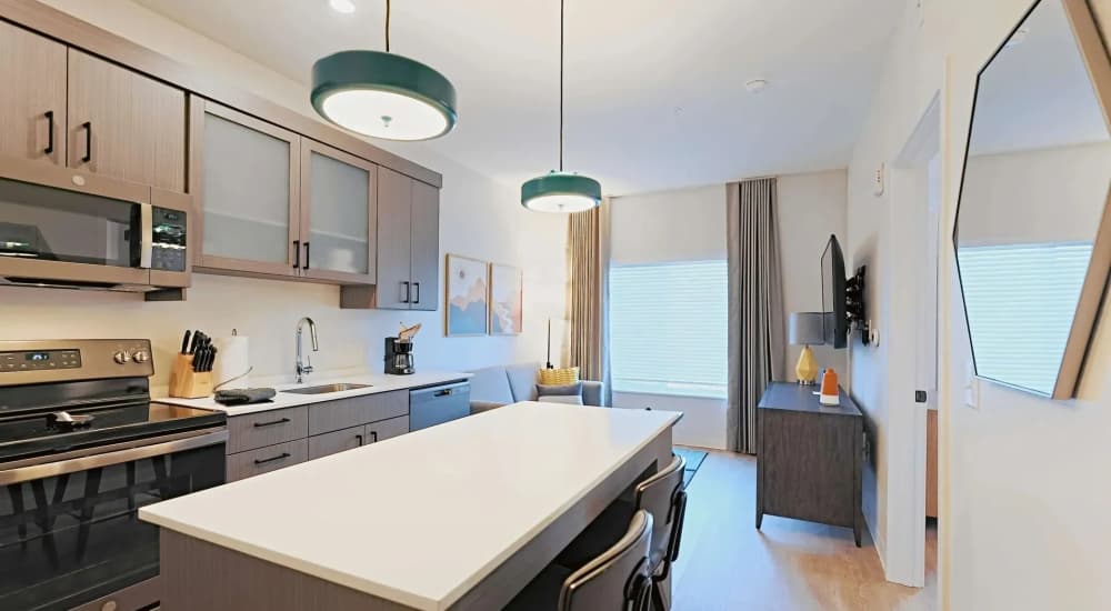 Kitchen with island countertop and modern appliances at WaterWalk Boise - Meridian in Meridian, Idaho