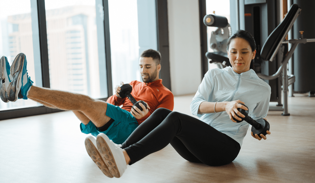 A man and woman doing an ab workout at Centra At North Druid Hills in Atlanta, Georgia