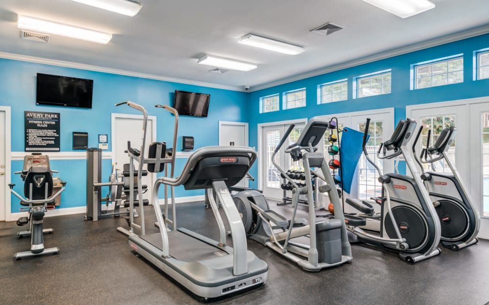 Well-equipped fitness center with cardio equipment at Avery Park Apartment Homes in Silver Spring, Maryland