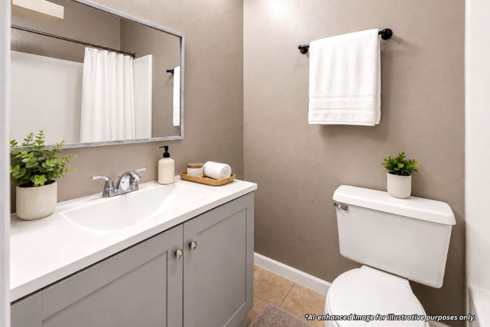 Digitally staged modern bathroom with gray cabinetry, large mirror, and shower area with white tiles at Towne East Village Apartment Homes in Converse, Texas