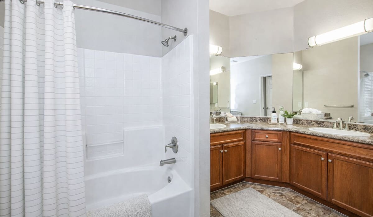 A bathroom with a tub and a shower at Westwood Bluffs in Fresno, California