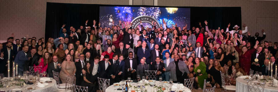 Team posing for a photo at an awards ceremony at our corporate offices at CLS Living in Austin, Texas