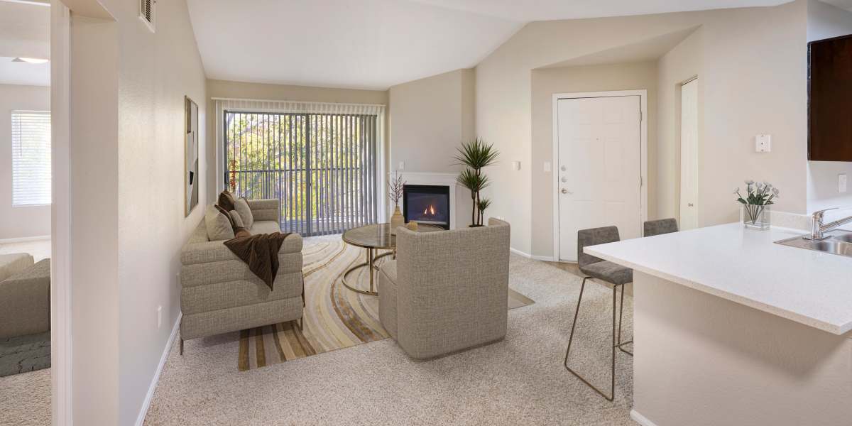 Beautiful living room with fireplace at The Crossings at Bear Creek Apartments in Lakewood, Colorado