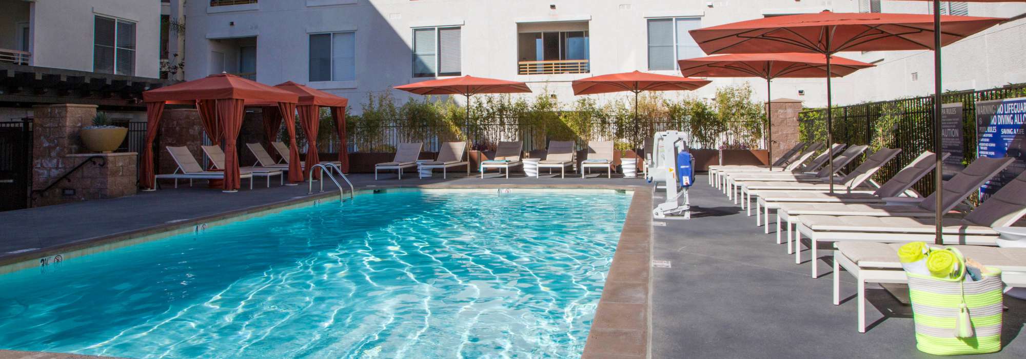 Spakling pool with lounge area at The Pointe at Warner Center in Woodland Hills, California