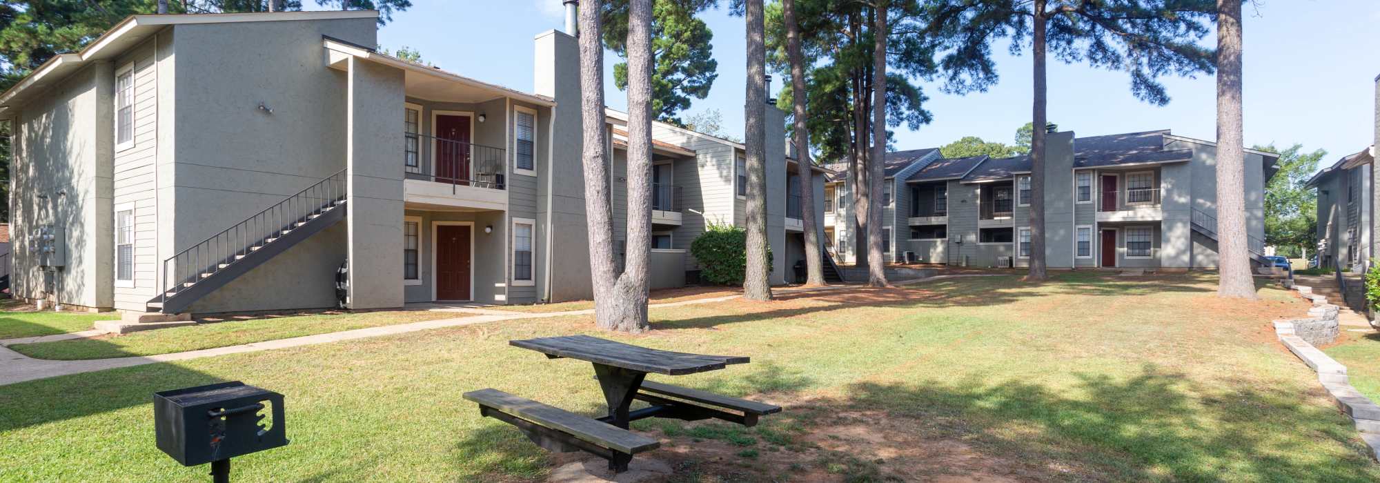Exterior shot of an apartment with picnic area at Southwood Village in Shreveport, Louisiana