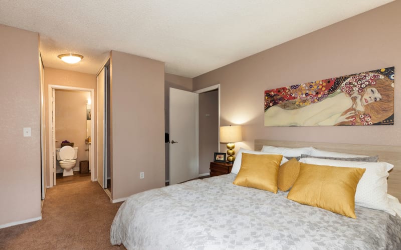 Spacious master bedroom with plush carpeting at The Woodlands Apartments in Sacramento, California