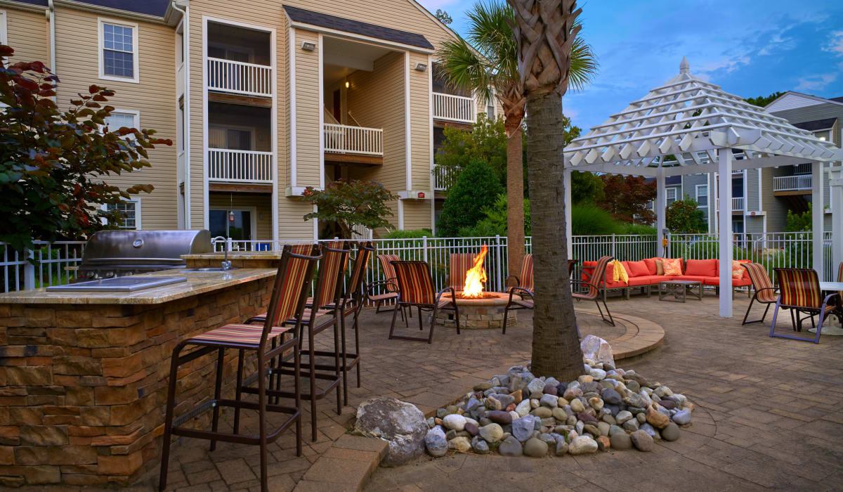 Outdoor kitchen and firepit area at Columbus Station Apartments at Town Center in Virginia Beach, Virginia