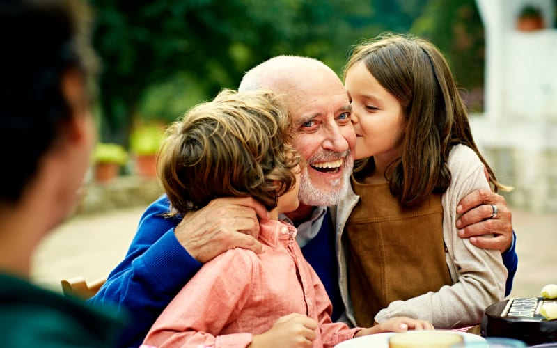 Happy grandfather with kids at Grand Villa of Lakeland in Lakeland, Florida