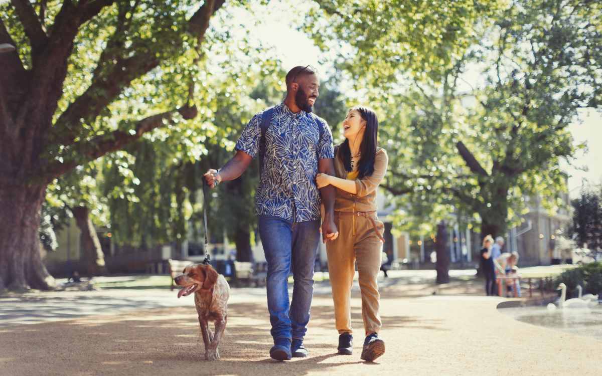 Resident couple walking their pup near their home at Vetra Asheville in Arden, North Carolina