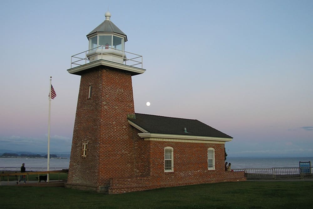 View of a local lighthouse at dusk near Pacific Shores apartments