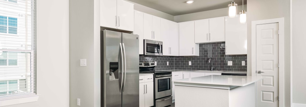 Spacious kitchen with a center island at Greenhouse in Houston, Texas