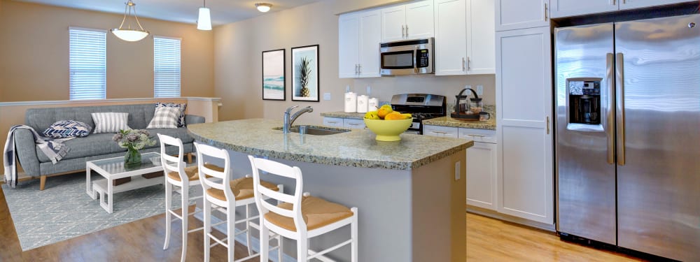 An open floor plan shows off the kitchen and living room at Palisades Sierra Del Oro in Corona, California