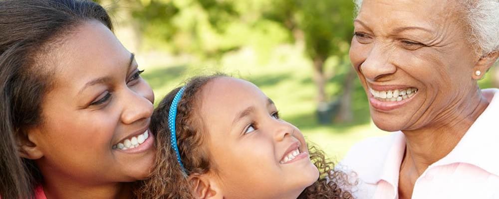 Resident and grandchild smiling outside at WellQuest of Granite Bay in Granite Bay, California
