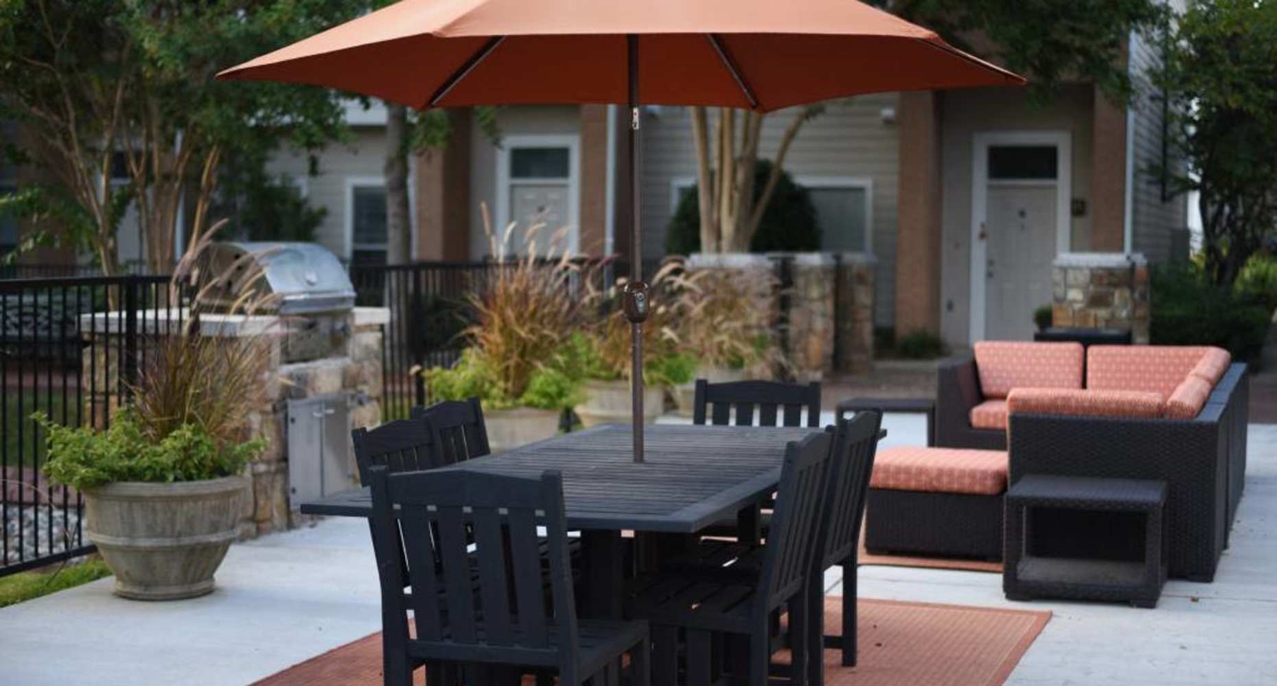 Outdoor lounge by the pool at Flatiron District at Austin Ranch in The Colony, Texas