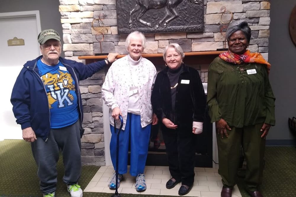 Team of ambassadors around the fireplace at Willow Creek Senior Living in Elizabethtown, Kentucky.