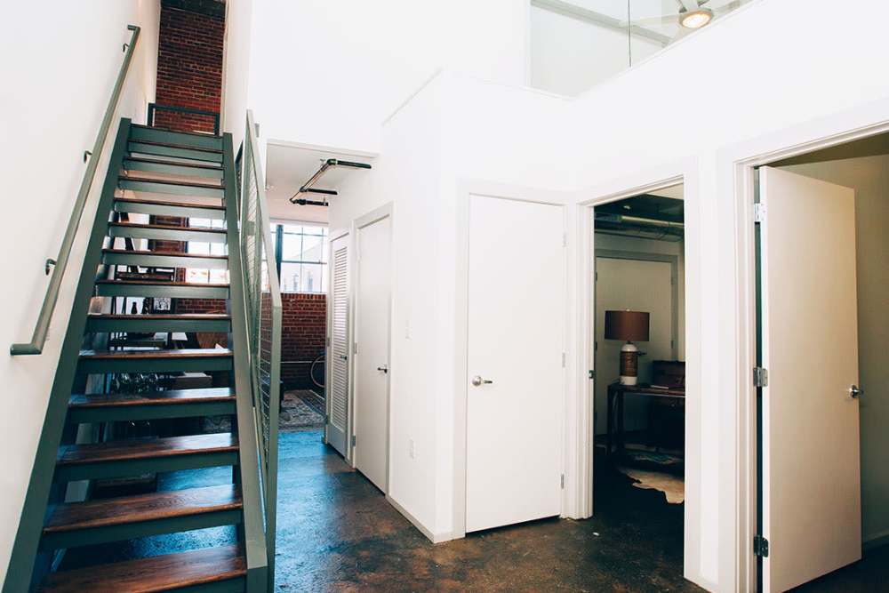 Stylish staircase in modern apartment entryway at Courtyard Lofts at Scott’s Addition in Richmond, Virginia