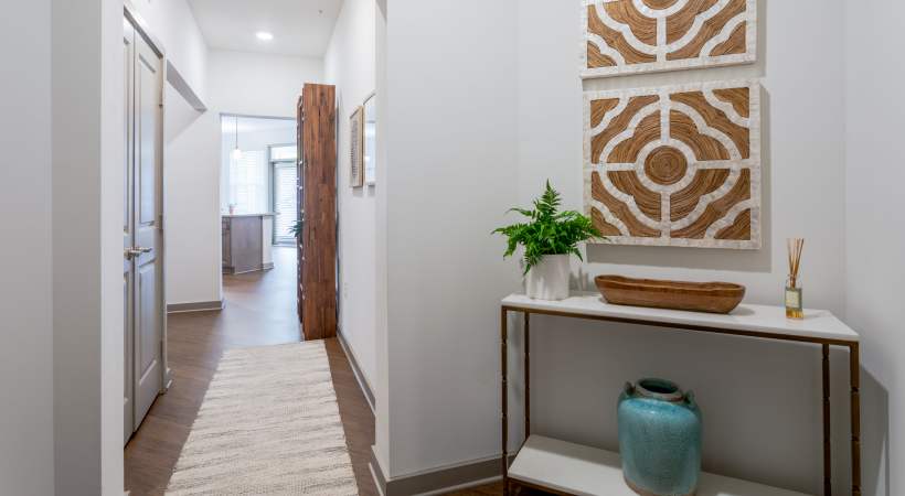 Hallway leading to an open living space with décor accents at The Banks at West Fork in Murfreesboro, Tennessee