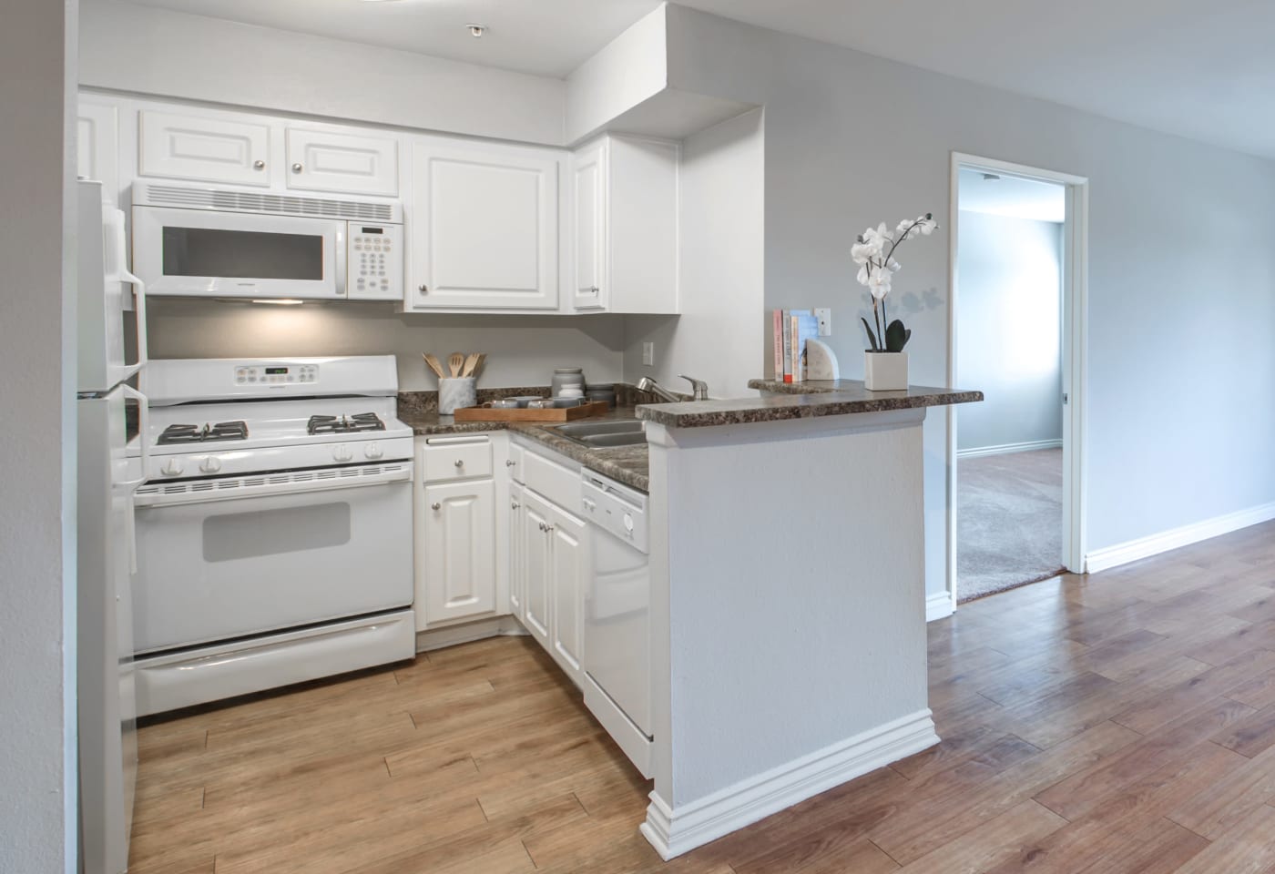 Chef-inspired kitchen with dark wood cabinetry at Vue at Laurel Canyon in Valley Village, California