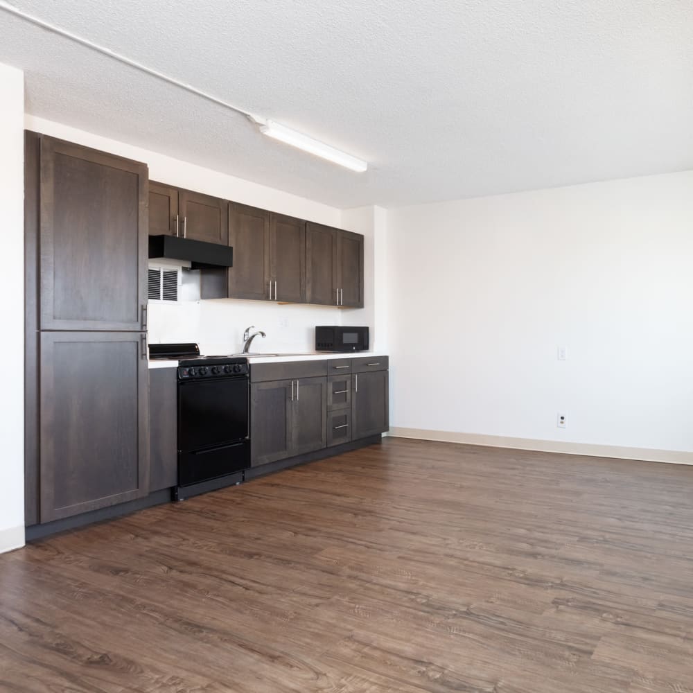 Open kitchen with sleek black appliances at Golden West Tower Apts in Torrance, California