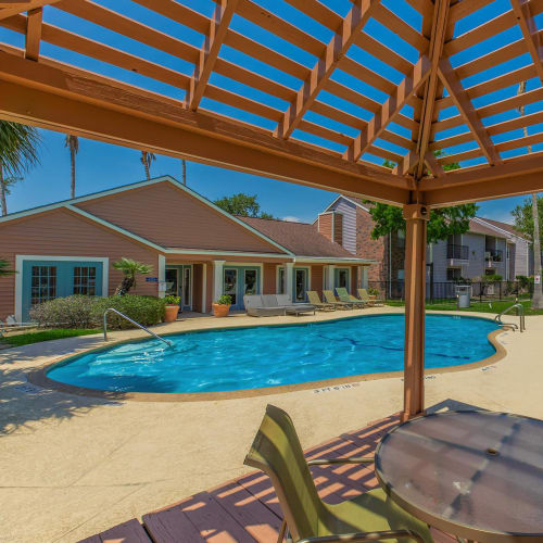 Swimming pool and patio in the shaded area at Water's Edge in Corpus Christi, Texas