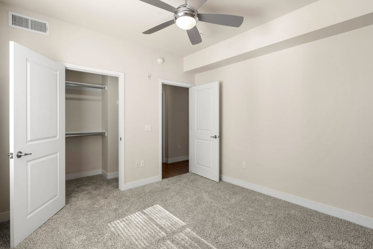 Bedroom with walk-in closet and carpet at Volta on Broadway, Tempe, Arizona