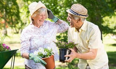 Two residents gardening at Arbors Memory Care in Sparks, NV