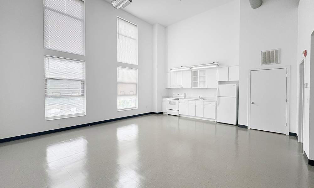 Kitchen with white appliances at Artspace Lofts Mount Rainier in Mount Rainier, Maryland