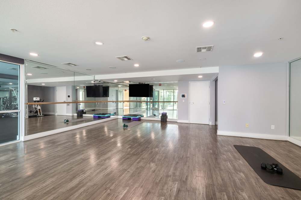 Luxury wood flooring with mirrors and weights at Capri Apartments in Marina Del Rey, California