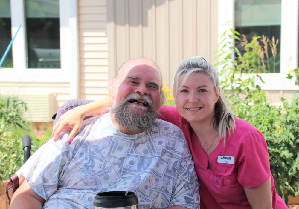 Happy resident and caregiver outside at East Troy Manor in East Troy, Wisconsin