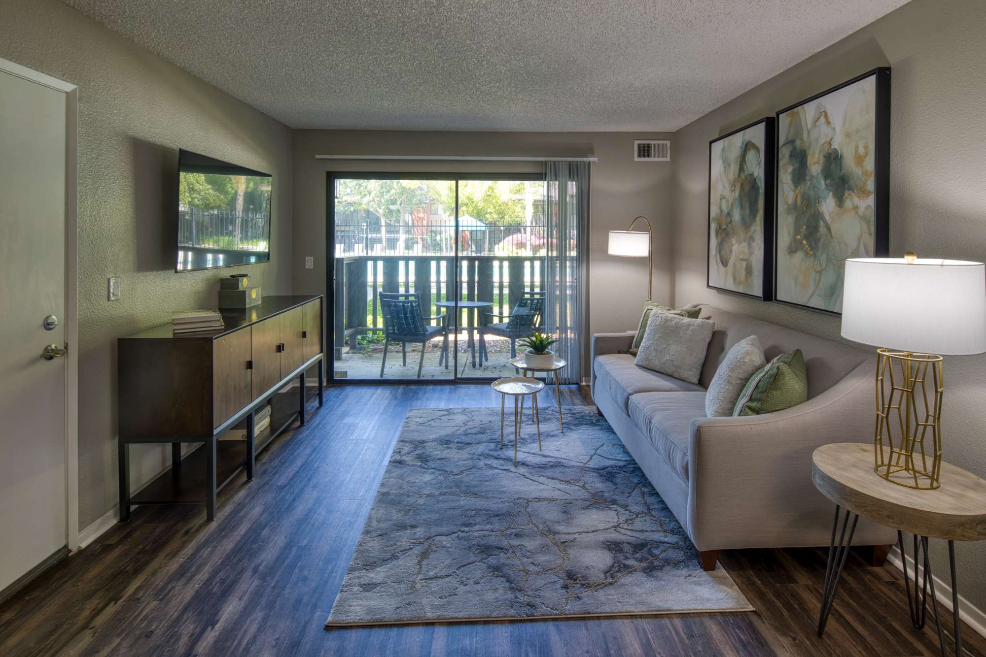 Living room with access to private balcony at Falls at Arden in Sacramento, California