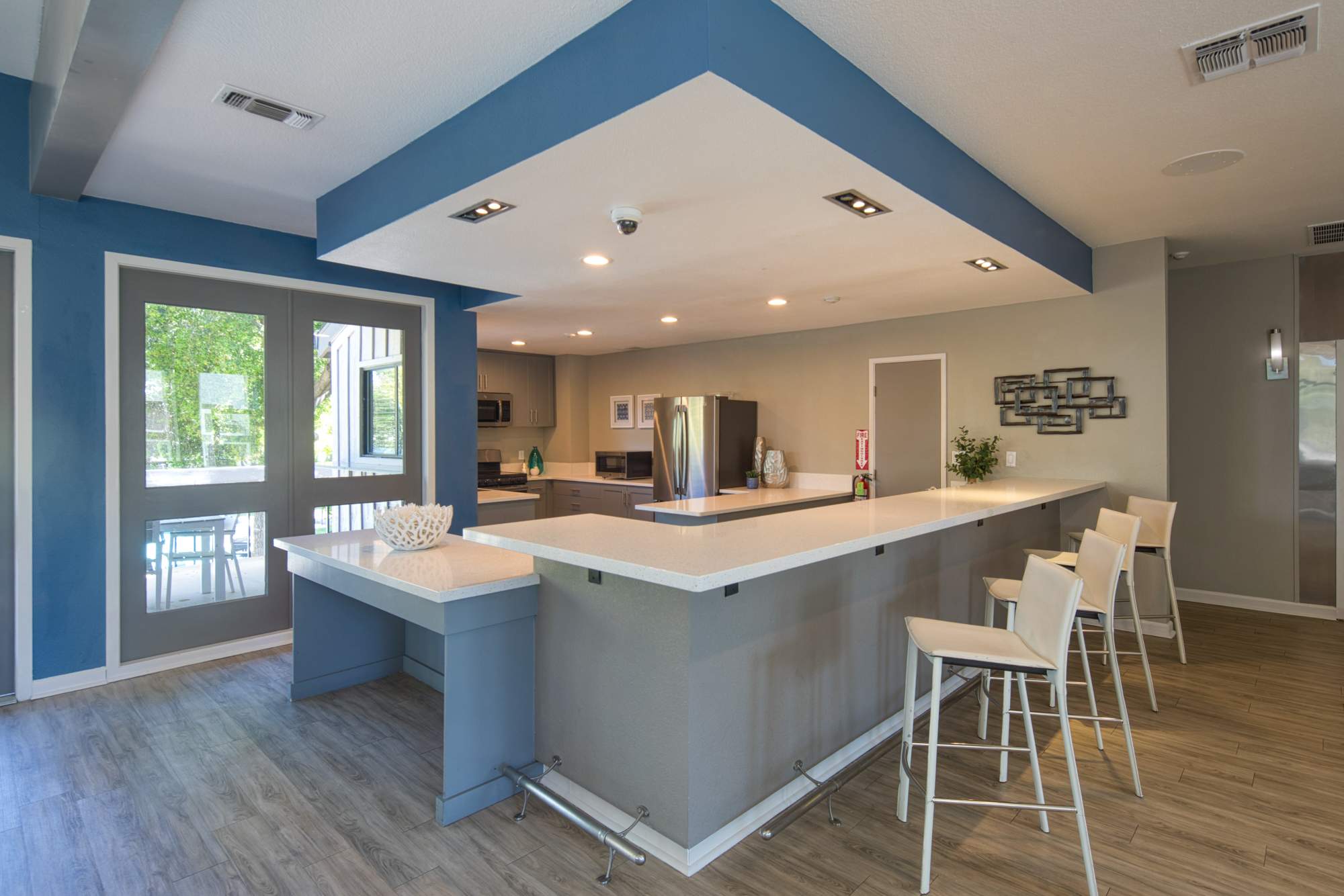 Community kitchen with quartz countertop and barstool at Falls at Arden in Sacramento, California