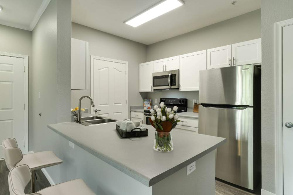 Kitchen with updated interiors and a dining area at The Grove at Orenco Station in Hillsboro, Oregon