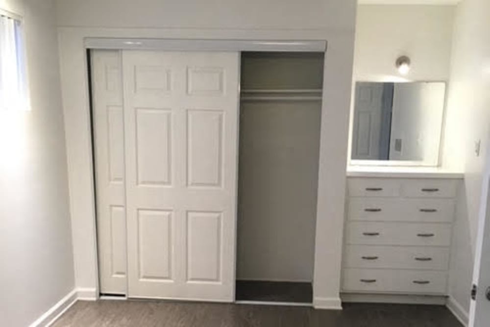 Bedroom with closet, mirror and drawers at  Occidental in Oxnard, California