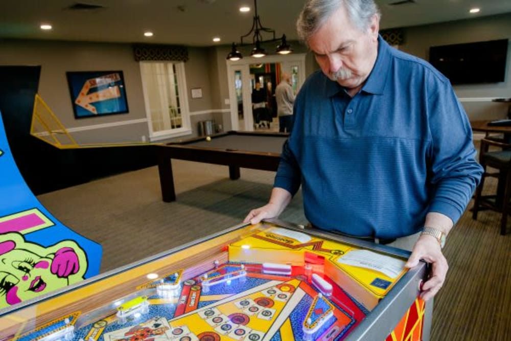 A resident playing pinball at Mercer Hill at Doylestown in Doylestown, Pennsylvania