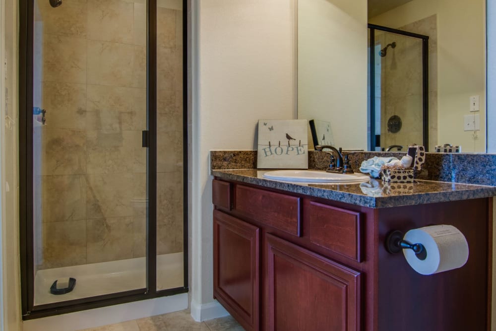 Bathroom with glass shower at Marquis Rockwall in Rockwall, Texas