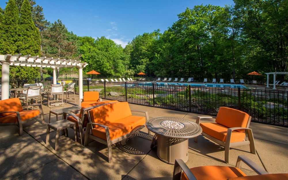 Pool area with chairs and tables at Aldingbrooke in West Bloomfield, Michigan