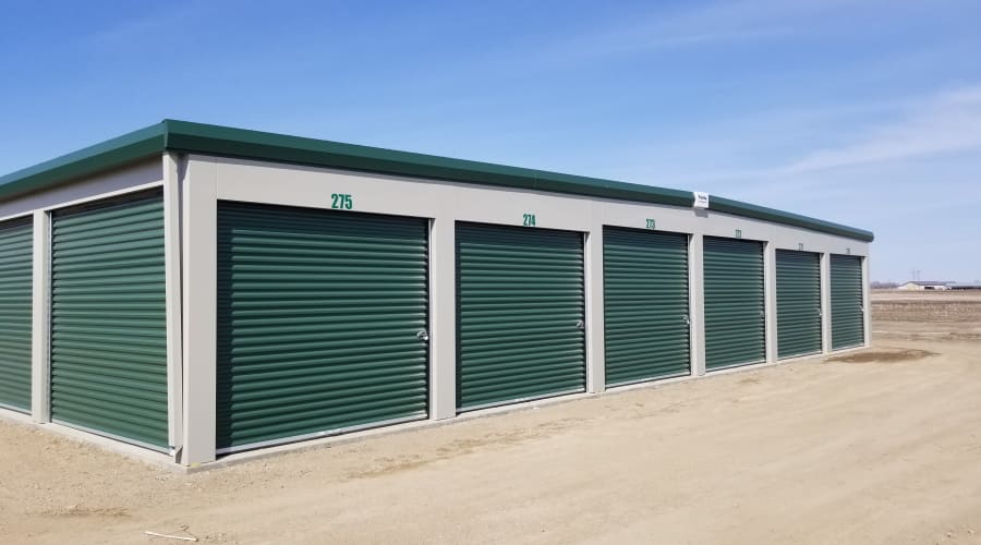 Storage units with green doors and locks at KO Storage in Aberdeen, South Dakota
