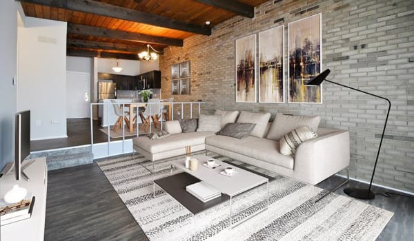 Living room with exposed brick at Crossings at Canton in Canton, Michigan