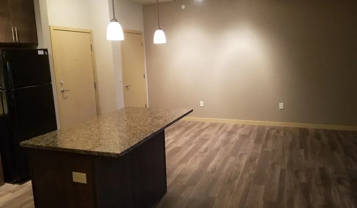 Granite countertops and vinyl plank flooring in the apartment at Mill Creek Apartments in Cross Plains, Wisconsin
