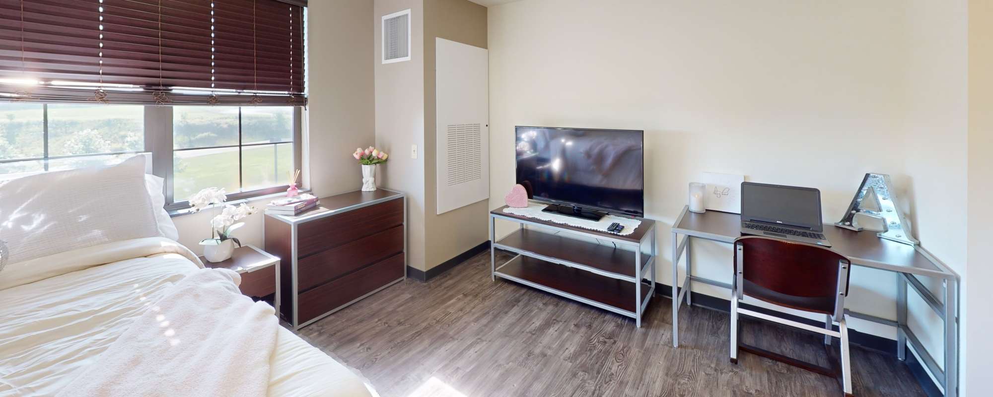 Bright bedroom along with television at Hudson Lofts in Erie, Pennsylvania