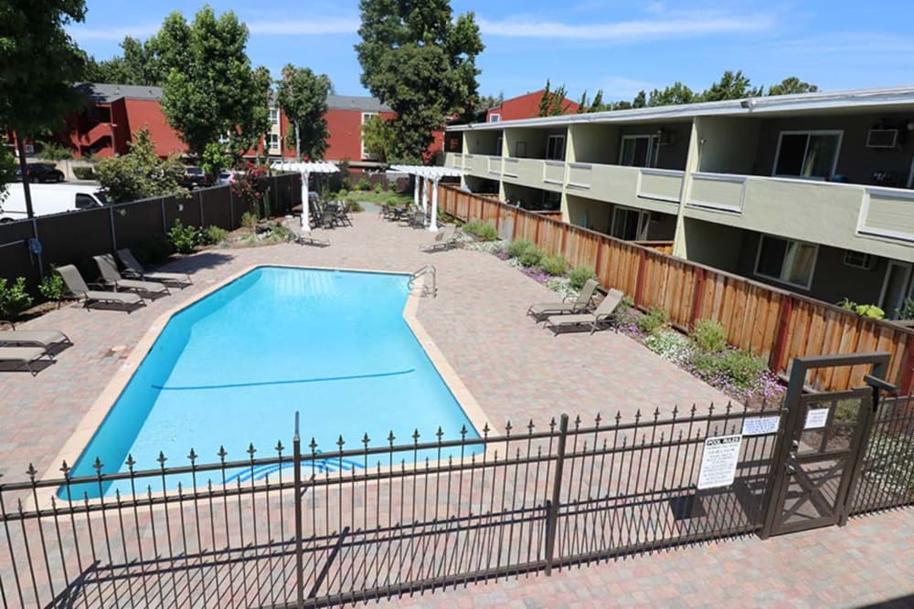 Chaise lounge chairs by the pool at Coronado Apartment Homes in Fremont, California